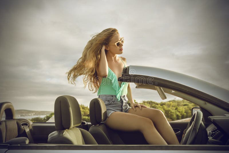 Elegant woman sitting in a classy car royalty free stock image Elegant woman sitting in a classy car royalty free stock image
