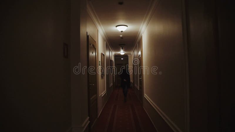 Elegant, young woman walking through hall in hotel