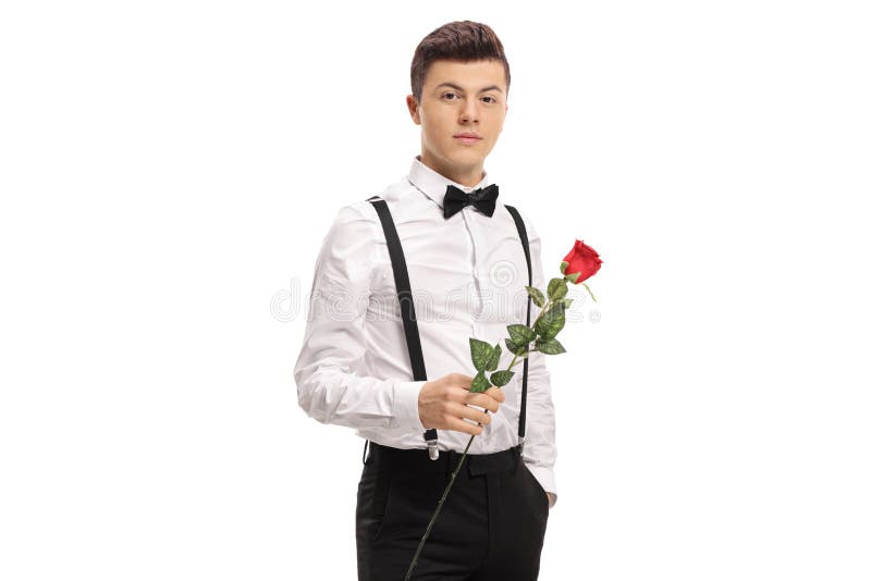 Elegantly dressed teenage boy holding a rose flower