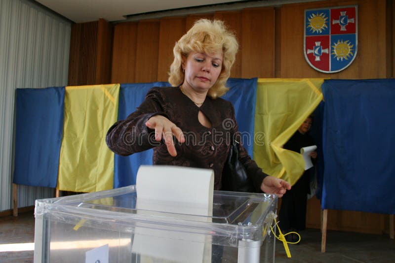 Parliamentary elections of Ukraine in 2007, September 30. Woman throw the ballot in a voting box. Parliamentary elections of Ukraine in 2007, September 30. Woman throw the ballot in a voting box