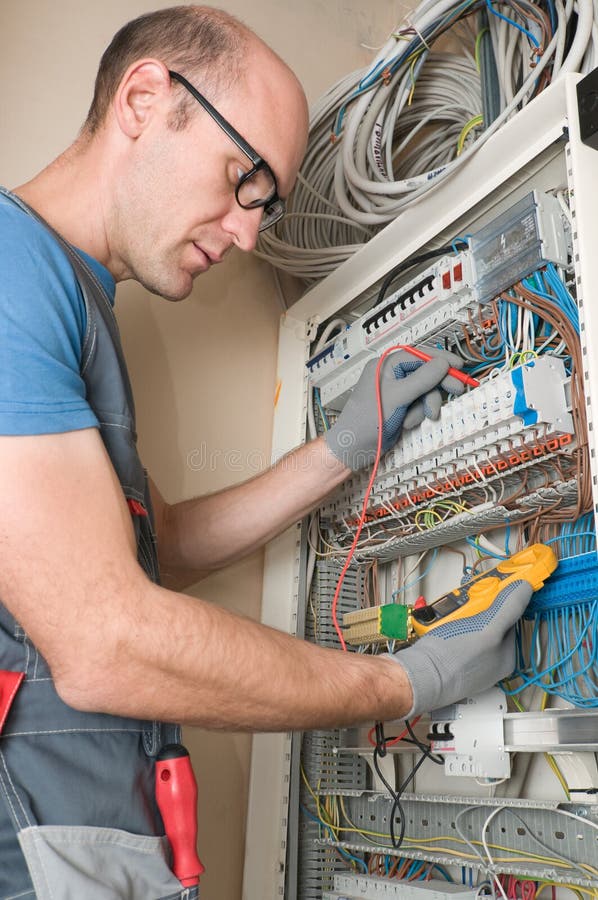 Electrician make connections in main electical panel. Electrician make connections in main electical panel