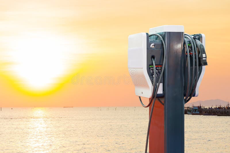 electric vehicle charging Ev station with plug of power cable supply for Ev car  on sun rise background. electric vehicle charging Ev station with plug of power cable supply for Ev car  on sun rise background.