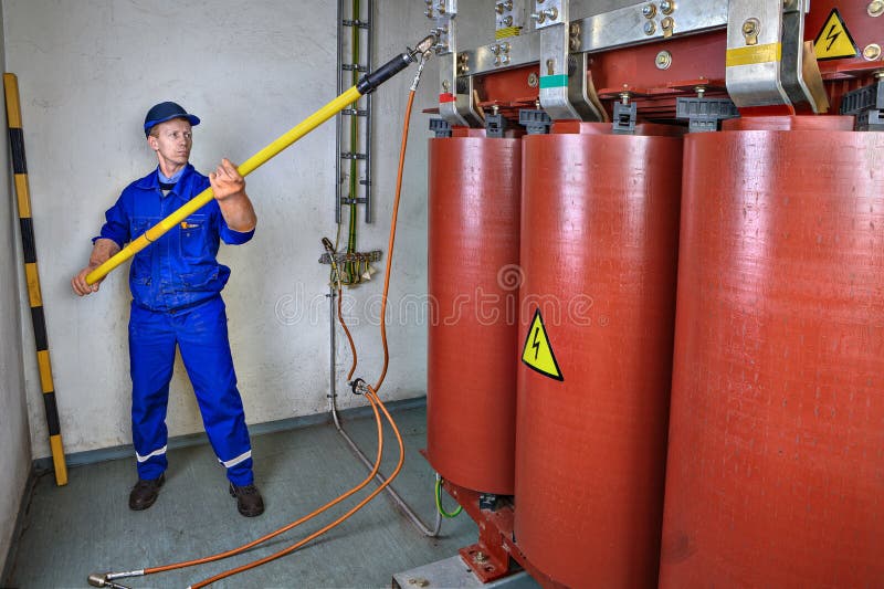 Elektryk używa rozładowanie kij ziemski transformator obraz stock Elektryk używa rozładowanie kij ziemski transformator obraz stock