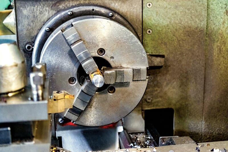 An element of a lathe for fixing a metal part for processing. Industrial processing of metal products with a cutting tool on an royalty free stock photo