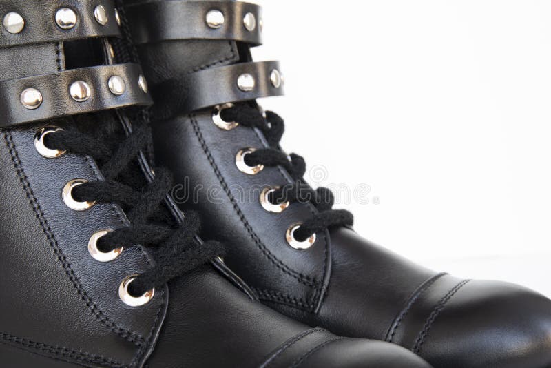 Element of woman leather black boots with metal knobs isolated on white background stock image