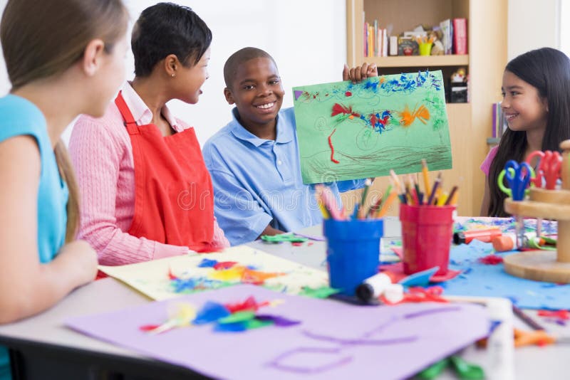 Elementary school art class with pupil discussing picture