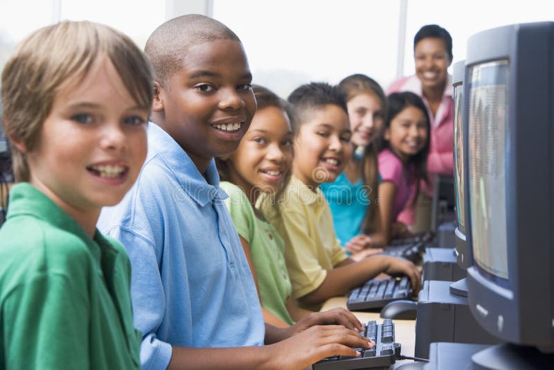 Elementary school computer class looking to camera