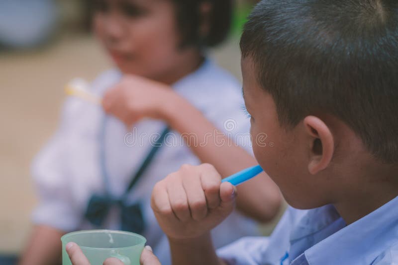 Elementary Students brush their teeth after lunch royalty free stock image
