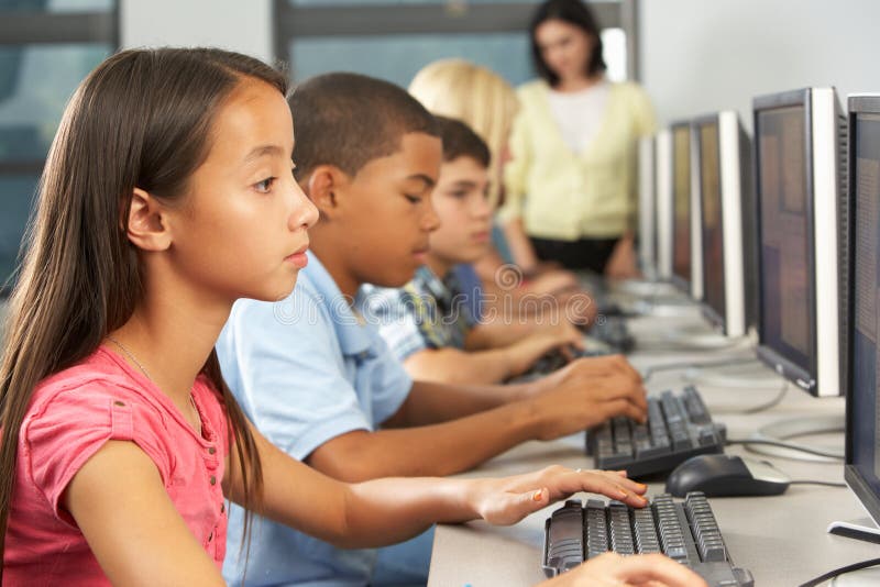 Elementary Students Working At Computers In Classroom Stock Photo