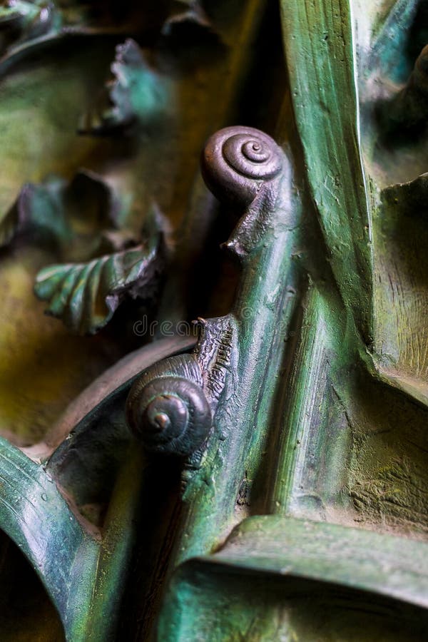 Elements of insects, flowers, birds of mammals on the old entrance gate to the Temple of the Holy Family.