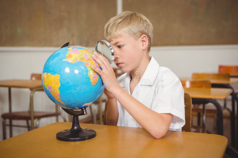 Elev care indică un loc pe un glob stock image