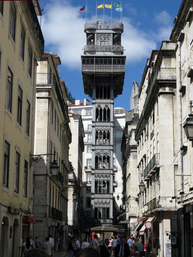 Full view of the Elevador de Santa Justa (or elevador do Carmo) from Rua de Santa Justa. The lift is a neo gothic 13m high tower built i 1874 by the architect Raul Mesnier de Ponsard that brings people up and down from the end rua de Santa Justa, in the lower baixa to the higher Largo do Carmo. Since its construction, the Lift has become a tourist attraction for Lisbon as, among the urban lifts in the city, Santa Justa is the only remaining vertical one.