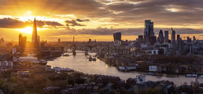 Elevated, panoramic view to the modern skyline of London from the Tower Bridge to the skyscrapers of the City during a colorful sunset, United Kingdom. Elevated, panoramic view to the modern skyline of London from the Tower Bridge to the skyscrapers of the City during a colorful sunset, United Kingdom