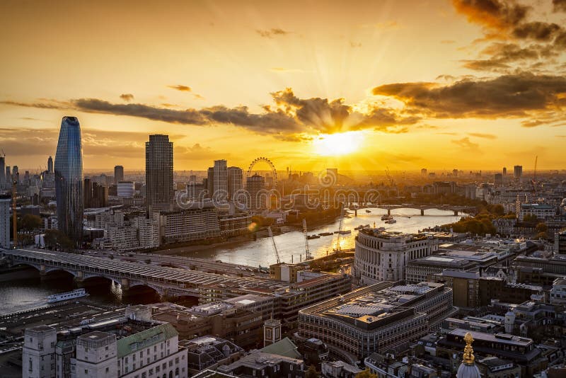 Elevated view to the iconic London skyline along the Thames river during sunset time, United Kingdom. Elevated view to the iconic London skyline along the Thames river during sunset time, United Kingdom