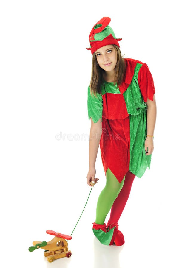 A pretty teen elf looking up at the viewer as she tests a pull-toy helicopter. On a white background. A pretty teen elf looking up at the viewer as she tests a pull-toy helicopter. On a white background.