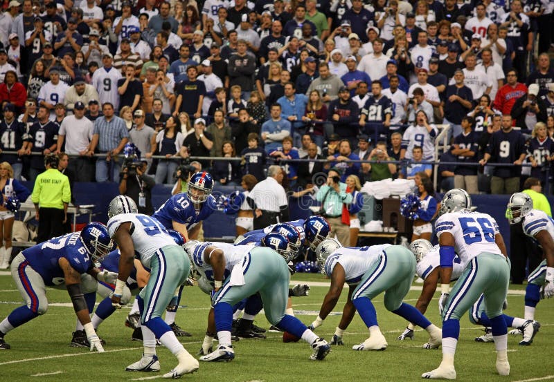 DALLAS - DEC 14: NY Giants quarterback Eli Manning prepares to receive the snap from center in a game with the Dallas Cowboys. Taken in Texas Stadium on Sunday, December 14, 2008. Editorial usefulness for - pro sports, pro football, Dallas Cowboys, New York Giants, Eli Manning, sports fans, sports celebrities. DALLAS - DEC 14: NY Giants quarterback Eli Manning prepares to receive the snap from center in a game with the Dallas Cowboys. Taken in Texas Stadium on Sunday, December 14, 2008. Editorial usefulness for - pro sports, pro football, Dallas Cowboys, New York Giants, Eli Manning, sports fans, sports celebrities.