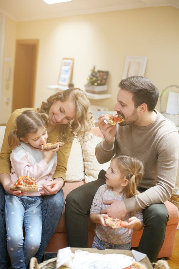 Eltern und Kinder, die zusammen Pizza essen Glückliches Familie enjoyin lizenzfreie stockfotografie Eltern und Kinder, die zusammen Pizza essen Glückliches Familie enjoyin lizenzfreie stockfotografie
