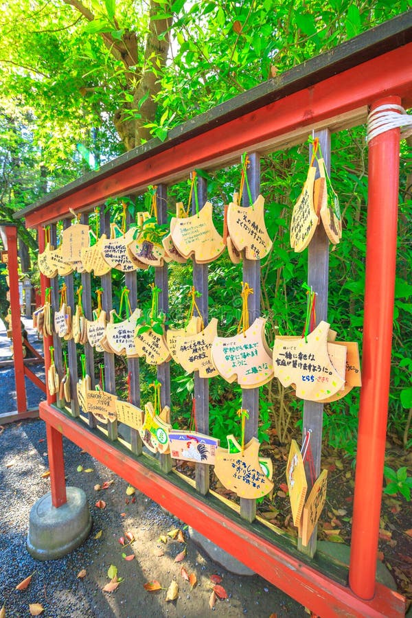 Kamakura, Japan - April 23, 2017: Ema praying tablets at Tsurugaoka Hachiman, the most important Shinto shrine built in 1063 in ancient Japan. Ema are small wooden plaques used for wishes. Kamakura, Japan - April 23, 2017: Ema praying tablets at Tsurugaoka Hachiman, the most important Shinto shrine built in 1063 in ancient Japan. Ema are small wooden plaques used for wishes.