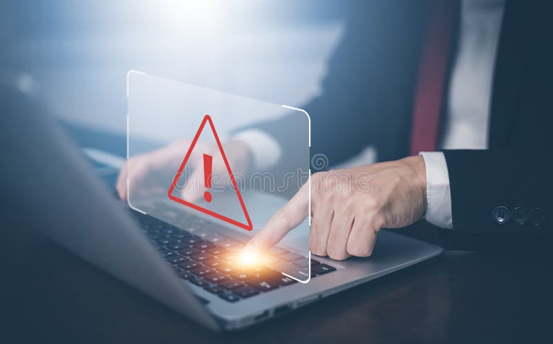 Businessman using laptop with triangle caution warning sign for notification error, Spam Email Pop-up Warning