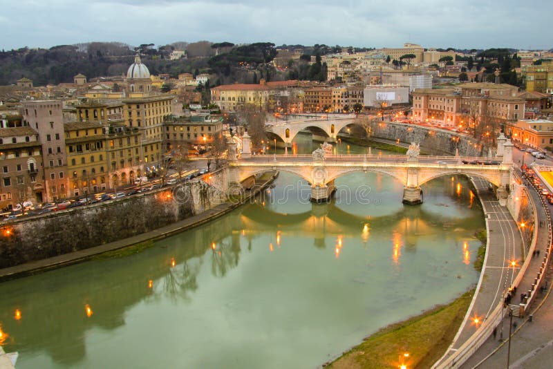 Night view of illuminated Ponte Vittorio Emanuele II over river Tiber in Rome, Italy. Night view of illuminated Ponte Vittorio Emanuele II over river Tiber in Rome, Italy.