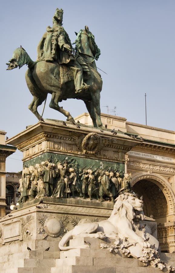 Picture of Vittorio Emanuele II Statue (Ercole Rosa, 1896) in Piazza del Duomo, Milan, Italy; shopping center Galleria Vittorio Emanuele II on the background. Picture of Vittorio Emanuele II Statue (Ercole Rosa, 1896) in Piazza del Duomo, Milan, Italy; shopping center Galleria Vittorio Emanuele II on the background