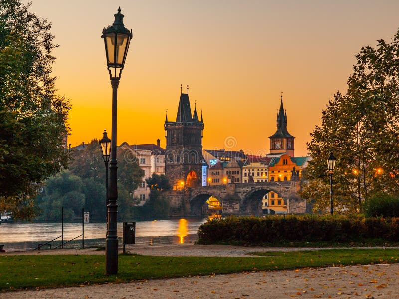 Embankment with old lamp in Old Town of Prague with Charles Bridge and Vltava river. Early morning shot. Prague, Czech