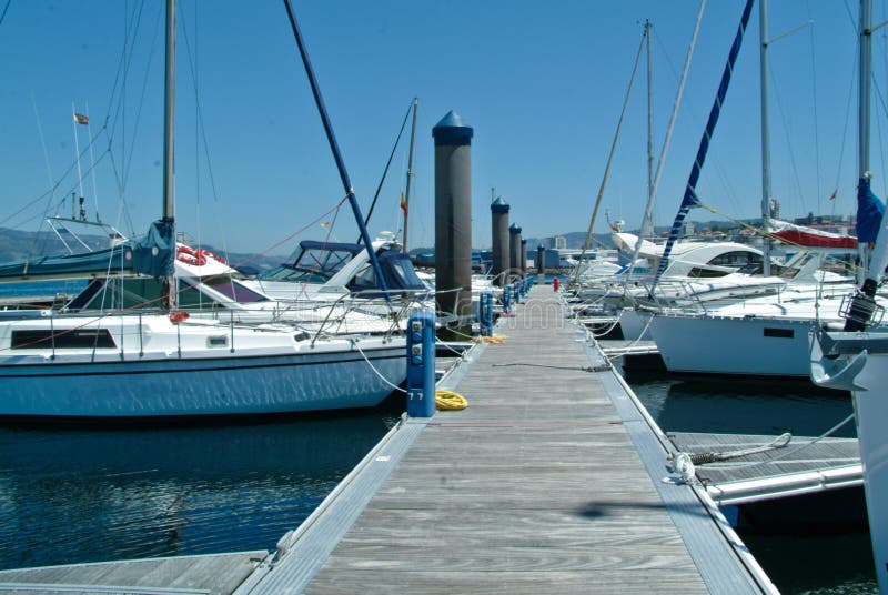 Ships docked on a docking bay on a sunny day. Ships docked on a docking bay on a sunny day