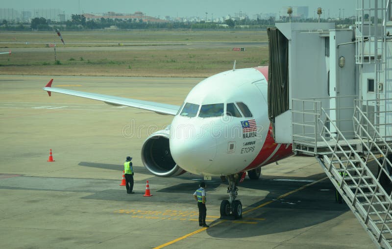 AirAsia airplane docking at airport in Penang, Malaysia. AirAsia airplane docking at airport in Penang, Malaysia.