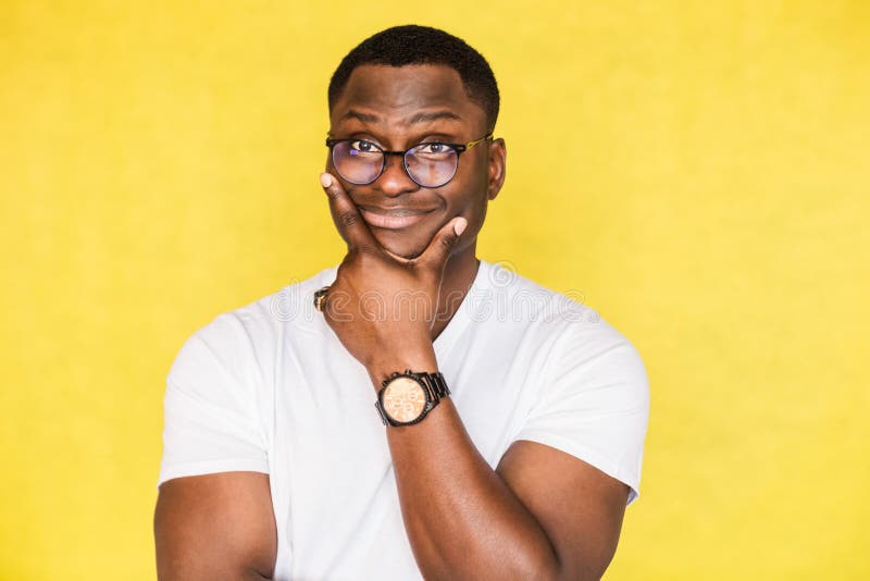 Embarrassed unsure African American man with glasses holds his chin and purses his lips, looks incredulously, tries to stock photos Embarrassed unsure African American man with glasses holds his chin and purses his lips, looks incredulously, tries to stock photos