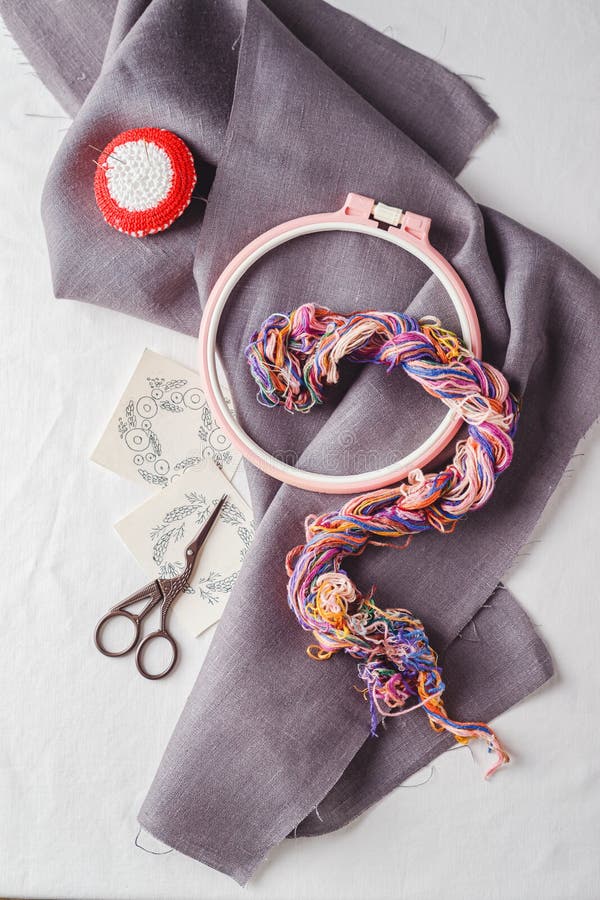 Embroidery set. Linen fabric, embroidery patterns, embroidery hoop, colorful threads and needls royalty free stock photos