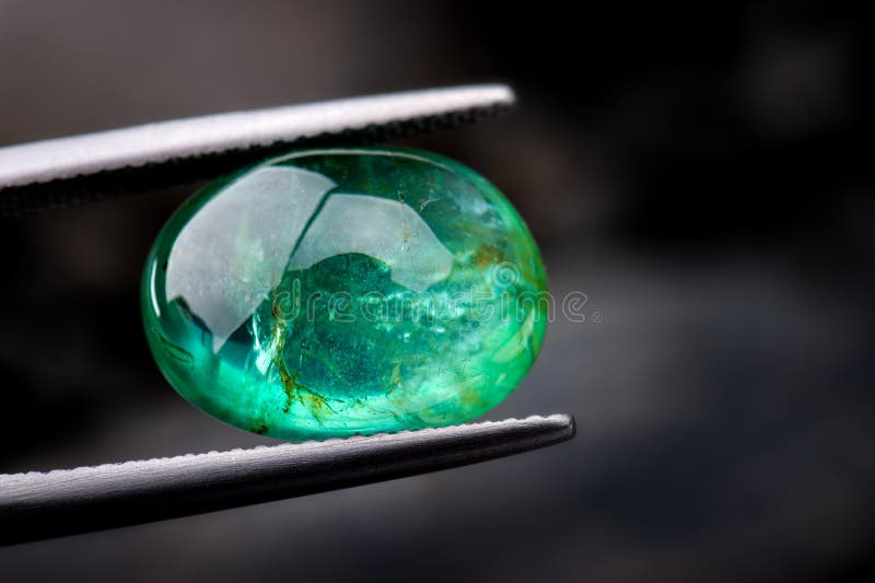 The emerald gemstone jewelry photo with dark lighting background. The emerald gemstone jewelry photo with dark lighting background