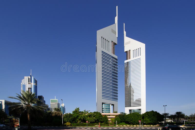 DUBAI - MAY 11: Emirates Towers at sunset time, 11 May 2014 in Dubai, UAE. Jumeirah Emirates Towers, Dubai's finest city hotel, is located in commercial business district. DUBAI - MAY 11: Emirates Towers at sunset time, 11 May 2014 in Dubai, UAE. Jumeirah Emirates Towers, Dubai's finest city hotel, is located in commercial business district.