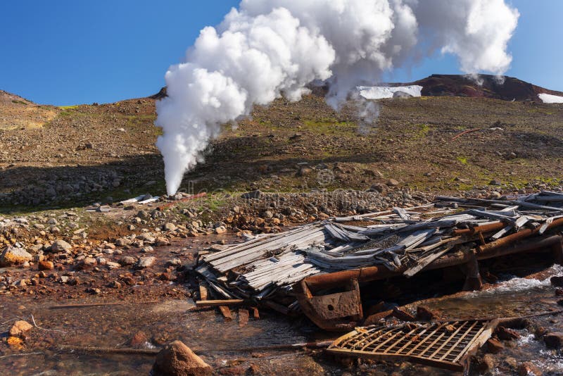 Emission of thermal steam-water mixture from well in geothermal deposit area royalty free stock photo Emission of thermal steam-water mixture from well in geothermal deposit area royalty free stock photo