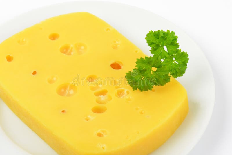Emmental cheese with holes stock image. Image of green 70539487