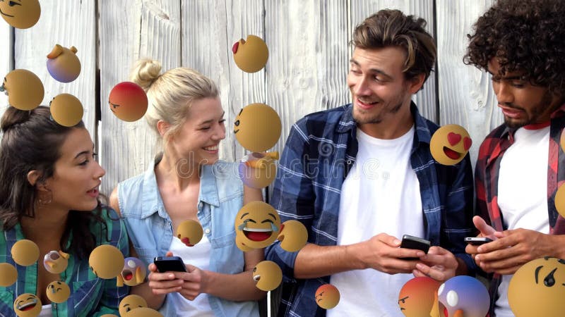 Emoji icons with a group of friends using smartphones in the background