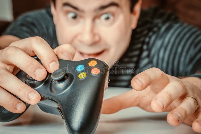 Emotional addicted man playing video games stock photo Emotional addicted man playing video games stock photo