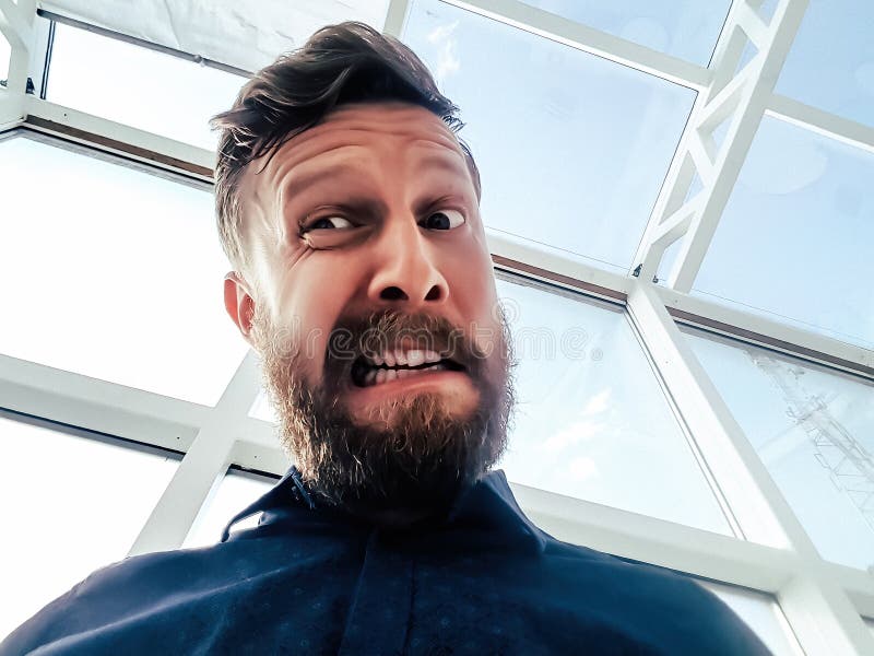 Close Up of Baffled Man with Long Beard on the Phone Stock Photo