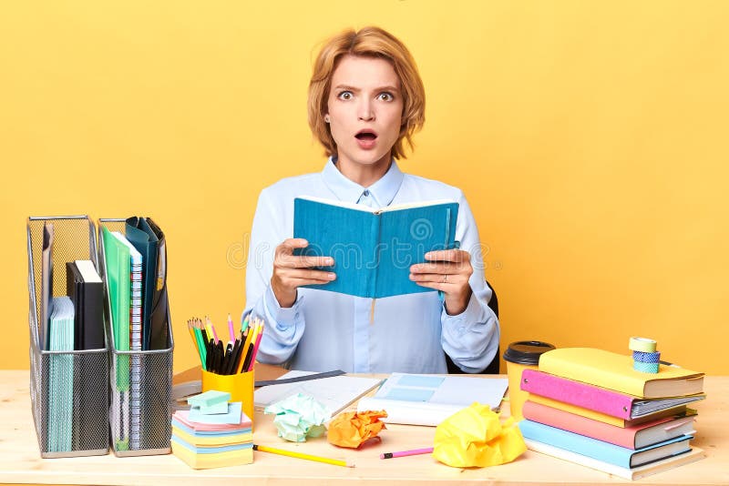Emotional blonde woman reading a book stock image