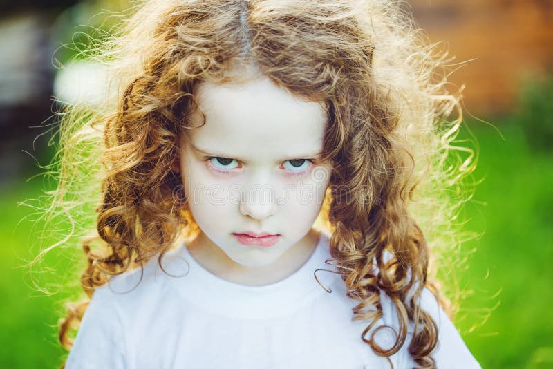 Emotional child with angry expression on face.