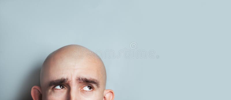 Emotional portrait of surprised bald man.