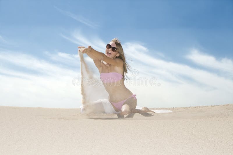 Emotional woman pouring sand from her hands.