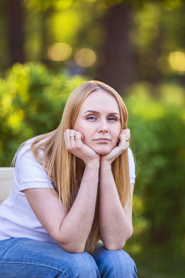 Emotions of the girl, fatigue, boredom, depression, sadness. Attractive bored young blond Caucasian woman holding her head with ha stock image Emotions of the girl, fatigue, boredom, depression, sadness. Attractive bored young blond Caucasian woman holding her head with ha stock image
