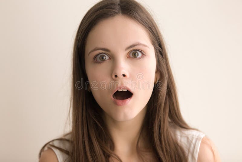 Emotive headshot portrait of puzzled young woman