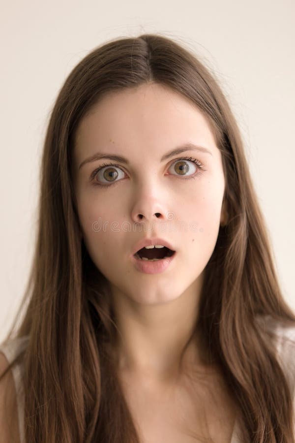 Emotive headshot portrait of stunned young woman stock images Emotive headshot portrait of stunned young woman stock images