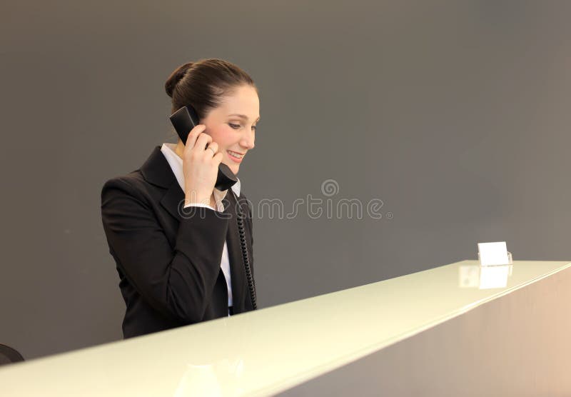 Pretty receptionist answering to the phone. Pretty receptionist answering to the phone