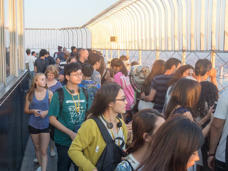 The Empire State Building observatory in New York City. Tourists at the Empire State Building observatory in New York City stock image The Empire State Building observatory in New York City. Tourists at the Empire State Building observatory in New York City stock image
