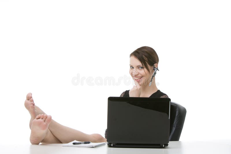 Empleado feliz que se sienta con sus pies en el escritorio imagenes de archivo Empleado feliz que se sienta con sus pies en el escritorio imagenes de archivo