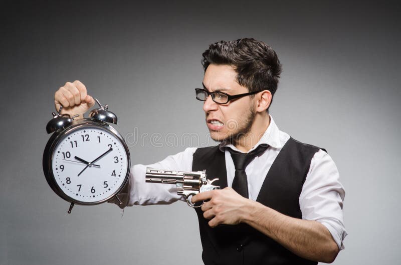 Employee holding alarm clock and handgun against