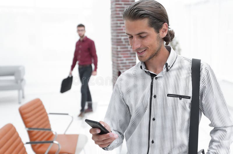 Employee reads a text message on smartphone stock photography
