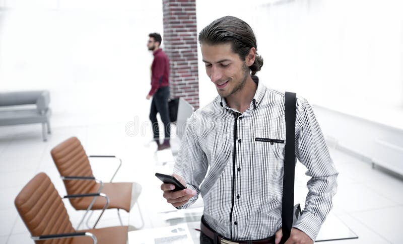 Employee reads a text message on smartphone stock photos